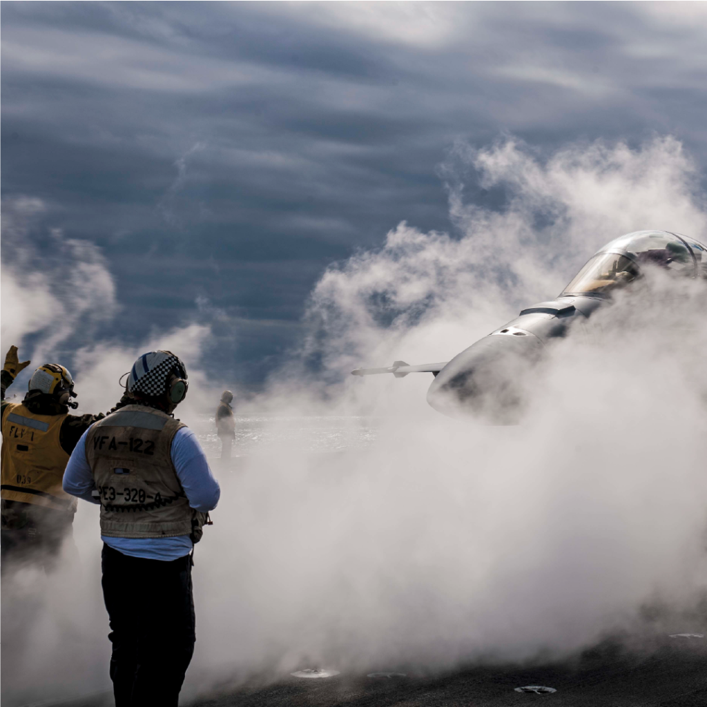 An Aircrewman in the U.S. Navy directs a fighter jet on the deck of a Navy aircraft carrier. Jets routinely produce over 160 decibels of noise.